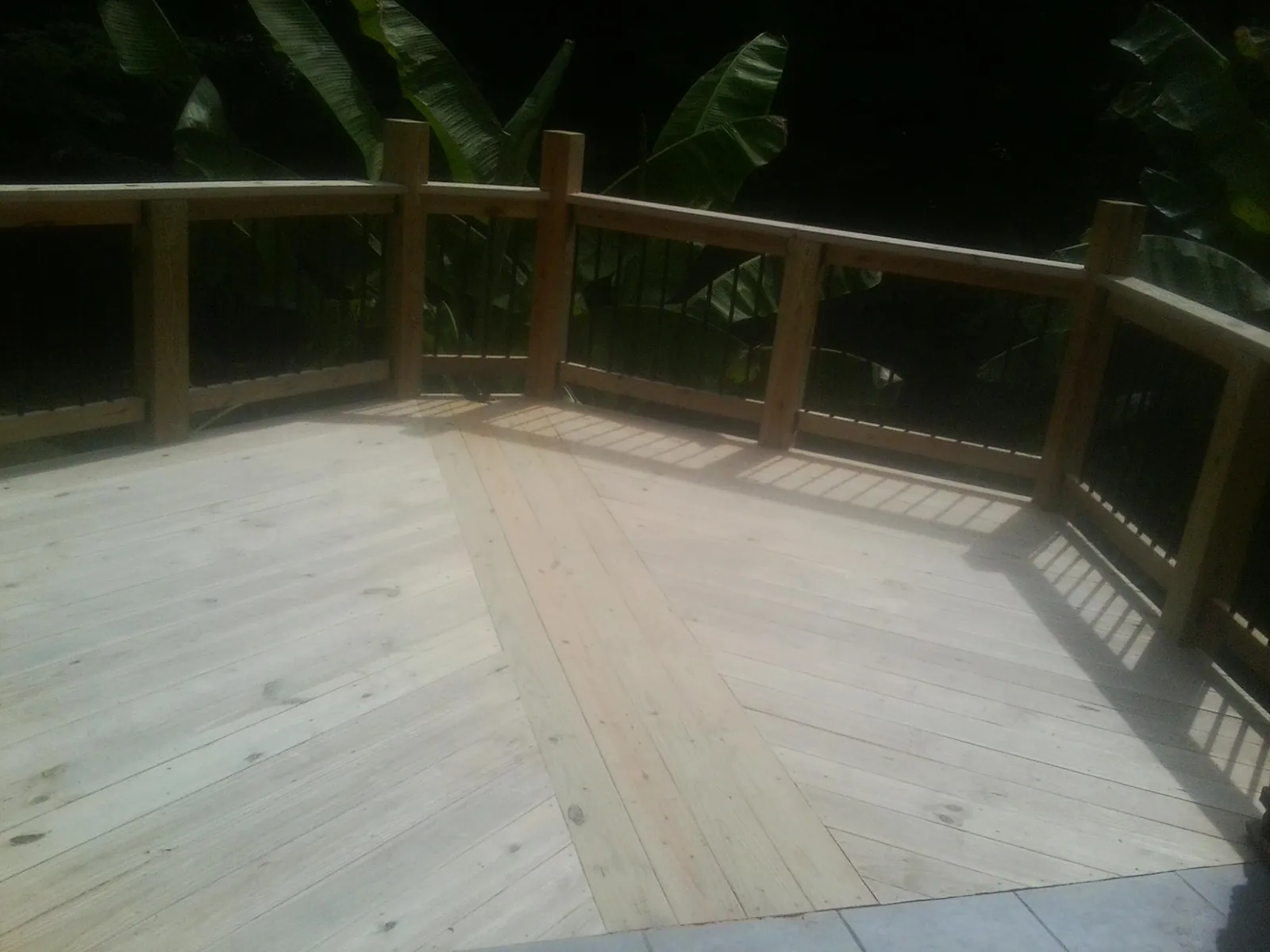 New wood deck and railing built off the back of a home in Urbana